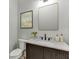 Stylish powder room featuring a marble countertop, dark wood vanity, and modern fixtures at 7620 Breeze Bay Rd, Cumming, GA 30041