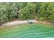 Beautiful waterfront property featuring a private sandy beach and covered boat dock at 7620 Breeze Bay Rd, Cumming, GA 30041