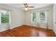 This is a cozy bedroom with hardwood floors and three bright, natural light-filled windows at 88 Karland Nw Dr, Atlanta, GA 30305