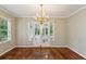 Elegant dining room featuring hardwood floors, a chandelier, and French doors opening to the outdoors at 88 Karland Nw Dr, Atlanta, GA 30305