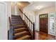 Elegant foyer with hardwood floors, staircase, and a traditional wooden front door, creating a welcoming atmosphere at 88 Karland Nw Dr, Atlanta, GA 30305