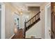 Traditional entryway features hardwood floors, staircase, and classic wallpaper, adding to the home's charm at 88 Karland Nw Dr, Atlanta, GA 30305