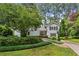 Charming home with a lush green lawn, mature trees, and decorative shrubbery enhancing its curb appeal at 88 Karland Nw Dr, Atlanta, GA 30305