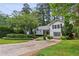 Inviting two-story home featuring manicured landscaping, a well-kept lawn, and a quaint front-facing garage at 88 Karland Nw Dr, Atlanta, GA 30305