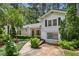 Well-maintained exterior with trimmed bushes, lush landscaping, a charming walkway, and an American flag at 88 Karland Nw Dr, Atlanta, GA 30305