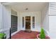Inviting front porch with brick flooring and a decorative front door, providing a warm welcome to the home at 88 Karland Nw Dr, Atlanta, GA 30305