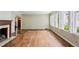 Spacious living room with hardwood floors, a decorative fireplace, and ample natural light from large windows at 88 Karland Nw Dr, Atlanta, GA 30305