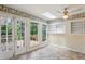 Charming sun room with tiled floor, skylight, ceiling fan, and doors to the deck at 88 Karland Nw Dr, Atlanta, GA 30305