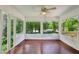 Enclosed sunroom boasting hardwood floors and beautiful backyard views through large windows at 88 Karland Nw Dr, Atlanta, GA 30305