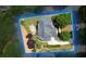 Aerial view of the house with a spacious backyard, complete with a patio seating area and lush landscaping at 2020 Windermere Xing, Cumming, GA 30041