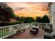 Back deck with stylish outdoor furniture and beautiful landscaping at sunset at 2020 Windermere Xing, Cumming, GA 30041