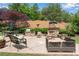 Outdoor patio area with built in stone fireplace and seating perfect for entertaining at 2020 Windermere Xing, Cumming, GA 30041