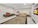 Finished basement with a seating area, a daybed, a treadmill, and a TV at 2020 Windermere Xing, Cumming, GA 30041