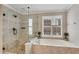 Bright bathroom showcasing a soaking tub and glass enclosed shower at 2020 Windermere Xing, Cumming, GA 30041
