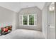 Minimalist bedroom with a window view and a TV in the corner at 2020 Windermere Xing, Cumming, GA 30041