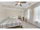 Cozy bedroom with decorative wainscotting, a ceiling fan, and a queen-sized bed at 2020 Windermere Xing, Cumming, GA 30041
