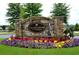 Stone entrance sign for Village Center at Windermere with colorful flower beds at 2020 Windermere Xing, Cumming, GA 30041