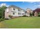 Rear exterior view of home showcasing large yard and brick/siding design at 2020 Windermere Xing, Cumming, GA 30041