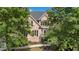 Traditional brick home showcasing a bay window and classic architectural details, framed by lush greenery at 2020 Windermere Xing, Cumming, GA 30041