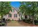 Charming two-story brick home with a well-manicured lawn and mature trees, offering great curb appeal at 2020 Windermere Xing, Cumming, GA 30041