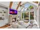 Inviting living area with stone fireplace, built-in shelves, and ample natural light from large windows at 2020 Windermere Xing, Cumming, GA 30041