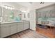Bright primary bathroom featuring a granite countertop, grey cabinets, and modern fixtures at 525 Watergate Ct, Roswell, GA 30076
