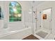 Bathroom featuring a glass door shower and large soaking tub at 525 Watergate Ct, Roswell, GA 30076