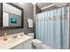 Bathroom with gray walls, shower with curtain, white vanity and toilet at 525 Watergate Ct, Roswell, GA 30076