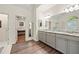 Bright bathroom featuring a granite countertop, grey cabinets, and modern fixtures at 525 Watergate Ct, Roswell, GA 30076