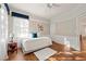 Cozy bedroom with natural light, wood floors, ceiling fan, and white and blue decor at 525 Watergate Ct, Roswell, GA 30076