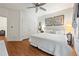Bright bedroom with wood floors, white walls, a ceiling fan, and closet at 525 Watergate Ct, Roswell, GA 30076