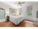 Bedroom with wood floors, ceiling fan, two windows, and an ensuite bathroom at 525 Watergate Ct, Roswell, GA 30076