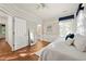 Bedroom with wood floors, white wainscoting, white trim, and decoratively pillowed bed at 525 Watergate Ct, Roswell, GA 30076