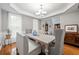 Cozy dining room featuring neutral tones, updated lighting and a view of the foyer at 525 Watergate Ct, Roswell, GA 30076
