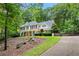 Traditional two-story home featuring a brick facade, well-manicured lawn, and lush landscaping at 525 Watergate Ct, Roswell, GA 30076