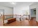 Upstairs landing with staircase, wood floors, and ample natural light creating a welcoming space at 525 Watergate Ct, Roswell, GA 30076