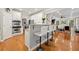 Bright eat-in kitchen features stainless appliances, granite counters, and an adjacent living room space at 525 Watergate Ct, Roswell, GA 30076