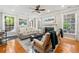 Bright living room boasting hardwood floors, large windows, and neutral decor at 525 Watergate Ct, Roswell, GA 30076