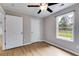 Bedroom featuring hardwood floors, neutral paint and a ceiling fan and a window at 159 Cranbrooke Dr, Dallas, GA 30157