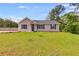 Inviting one-story home with a green lawn and classic design elements at 159 Cranbrooke Dr, Dallas, GA 30157