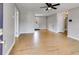 Open-concept living room with wood floors, neutral paint, and an abundance of natural light at 159 Cranbrooke Dr, Dallas, GA 30157