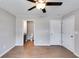 A spacious main bedroom featuring a ceiling fan, a glimpse of an ensuite bathroom and hardwood floors at 159 Cranbrooke Dr, Dallas, GA 30157
