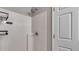 All-white shower featuring modern fixtures and wall-mounted storage for toiletries at 159 Cranbrooke Dr, Dallas, GA 30157