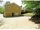 Back exterior view with an exterior access garage door at 2460 Due West Nw Cir, Kennesaw, GA 30152