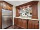 Basement bar area with granite counters, refrigerator and shelves at 2460 Due West Nw Cir, Kennesaw, GA 30152