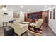 Basement seating area with leather couches, built-in entertainment center and wood-look floors at 2460 Due West Nw Cir, Kennesaw, GA 30152