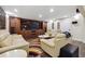 Basement with a bar, leather couches, built-in entertainment center, and wood-look floors at 2460 Due West Nw Cir, Kennesaw, GA 30152