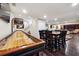 Finished basement features a shuffleboard table, bar seating, and a cozy seating area at 2460 Due West Nw Cir, Kennesaw, GA 30152