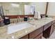 Bathroom featuring a double vanity and granite countertop with a white ceramic sink at 2460 Due West Nw Cir, Kennesaw, GA 30152
