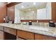 Bathroom featuring a double vanity and granite countertop with ceramic sinks at 2460 Due West Nw Cir, Kennesaw, GA 30152